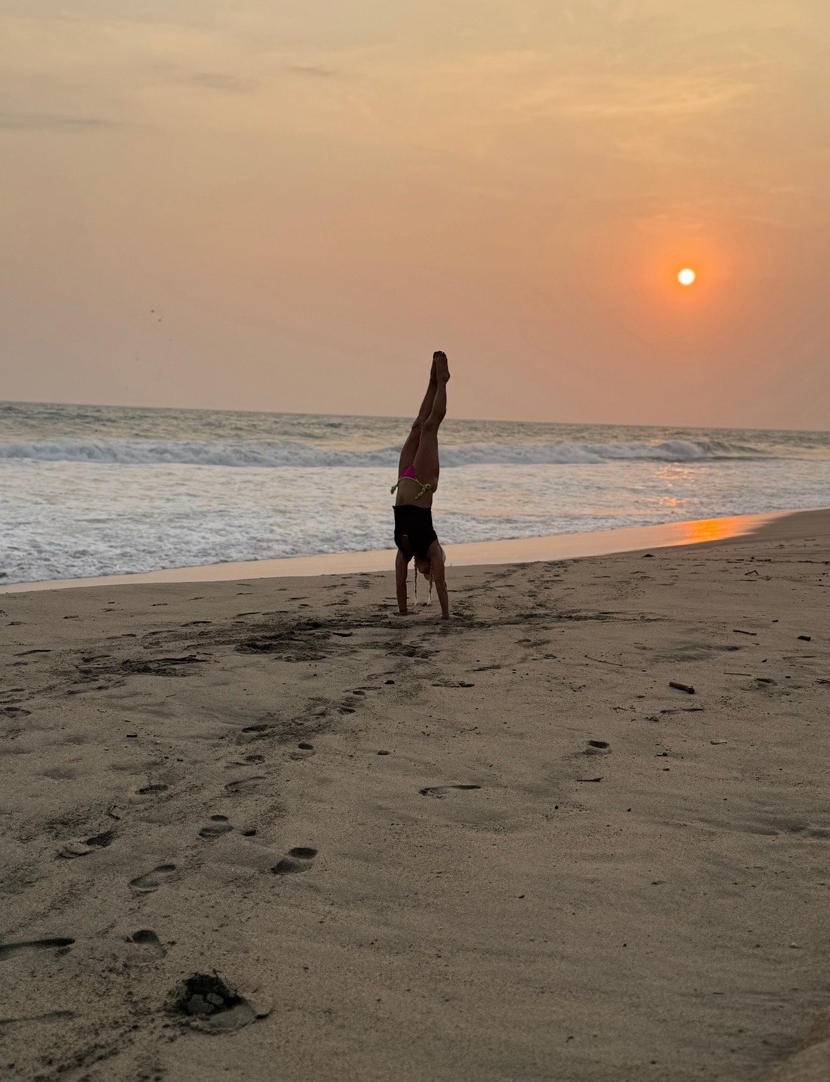 Handstand on the beach at sunset